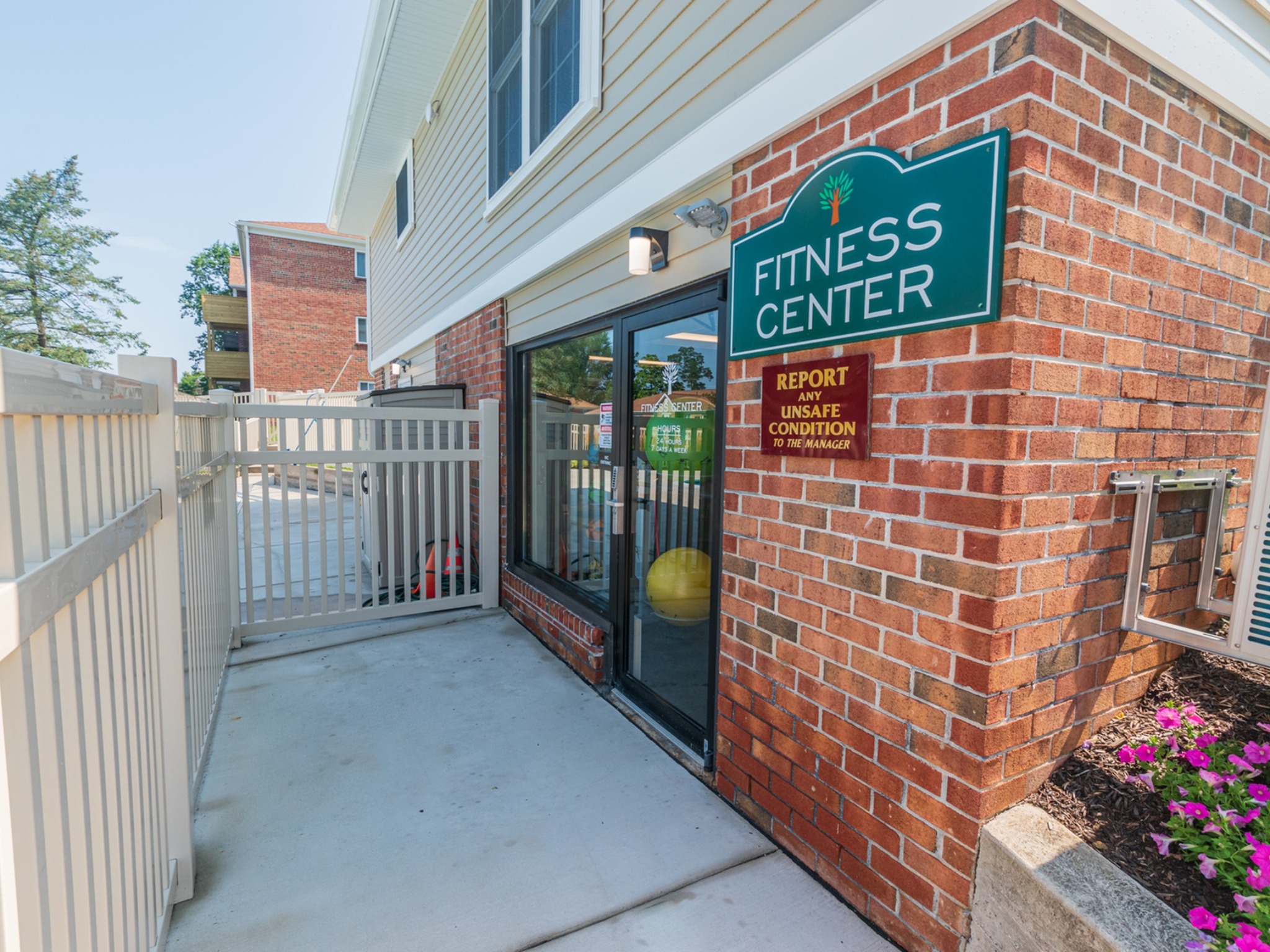 Entrance to fitness center, fitted with a paved walkway, and entrance