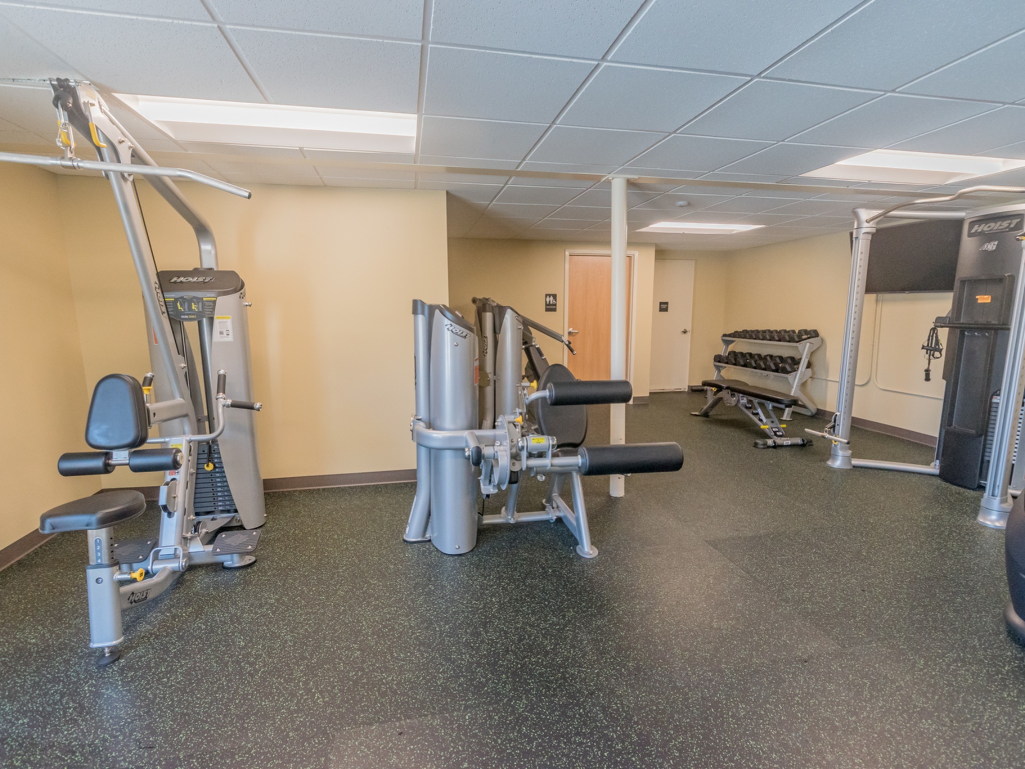 The fitness center area of our community, fitted with fitness equipment, and soft flooring