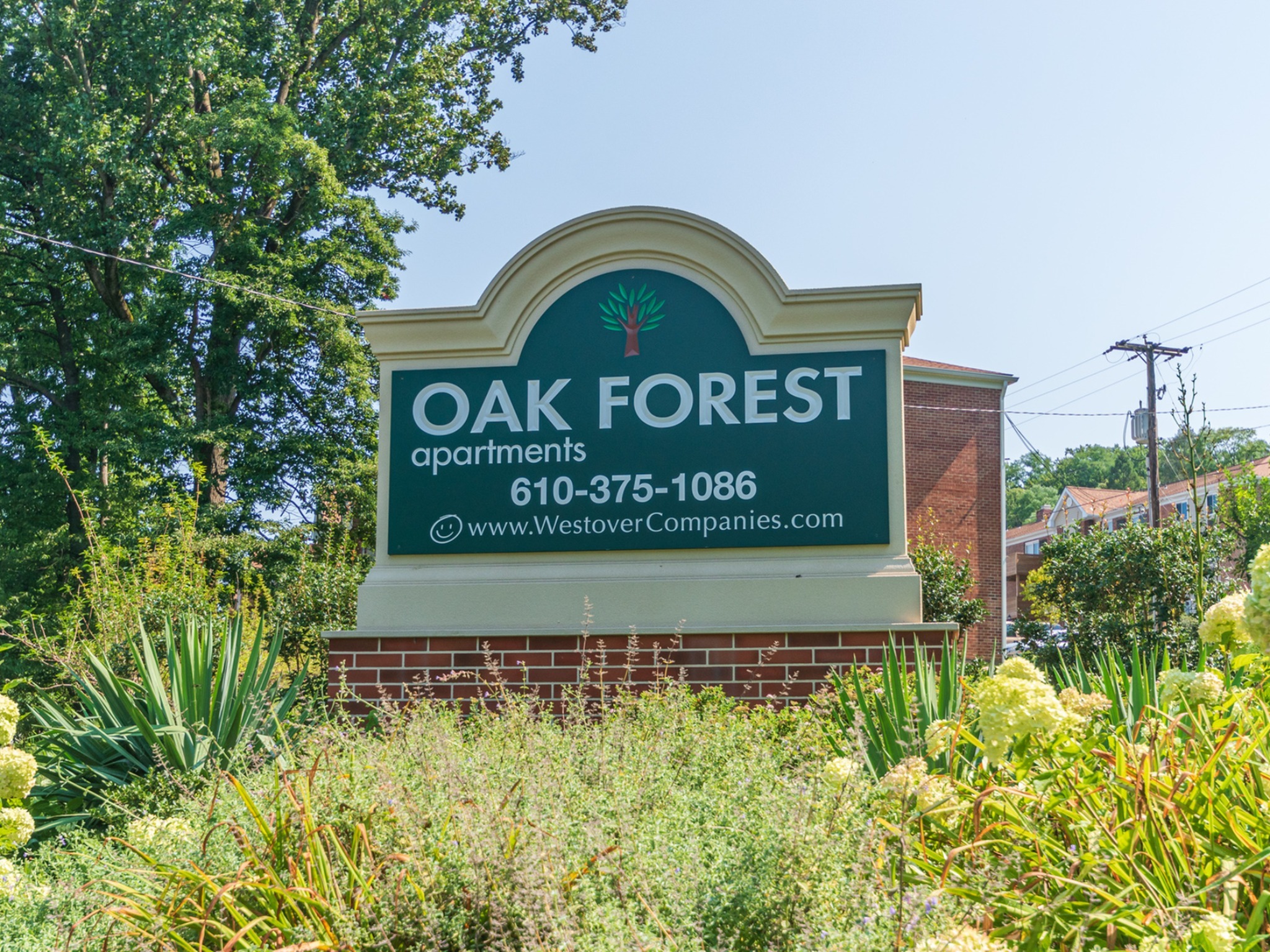 Oak Forest apartments welcome sign, fitted in a beautiful garden