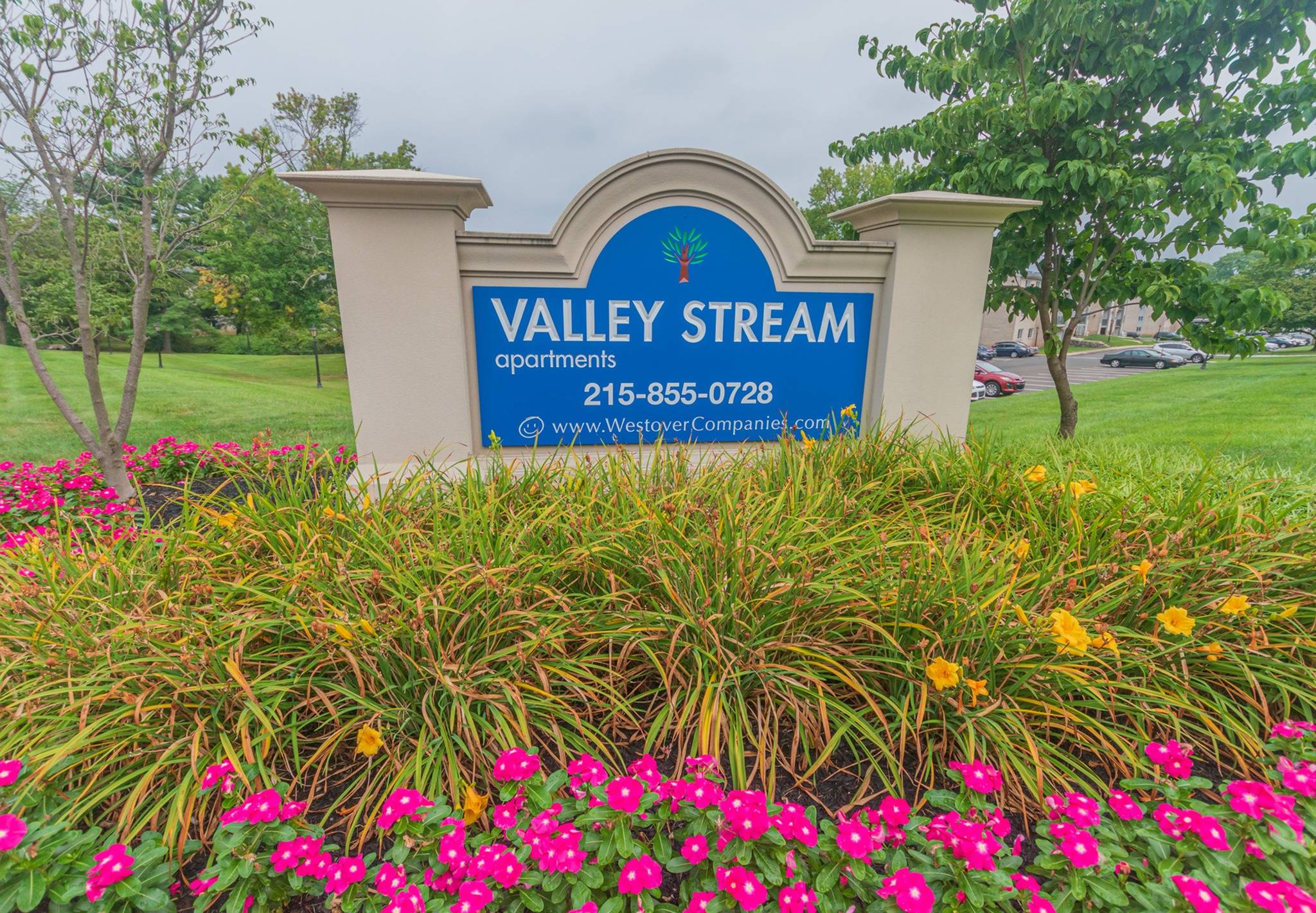 Valley Stream Signage with foliage in front of it