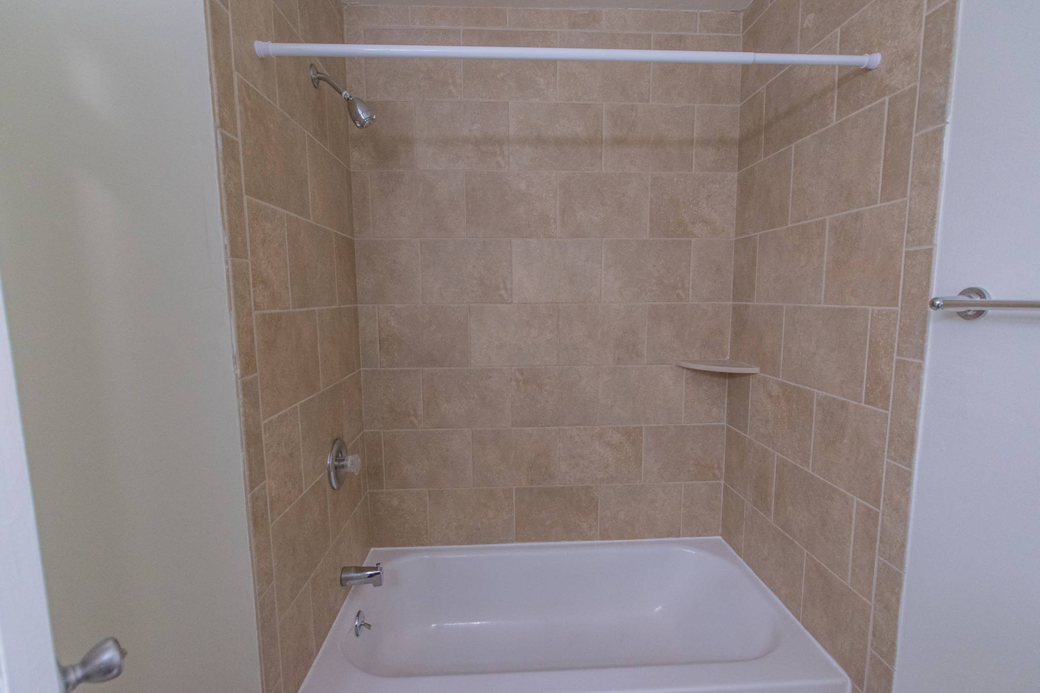 Shower tub inside a bathroom.