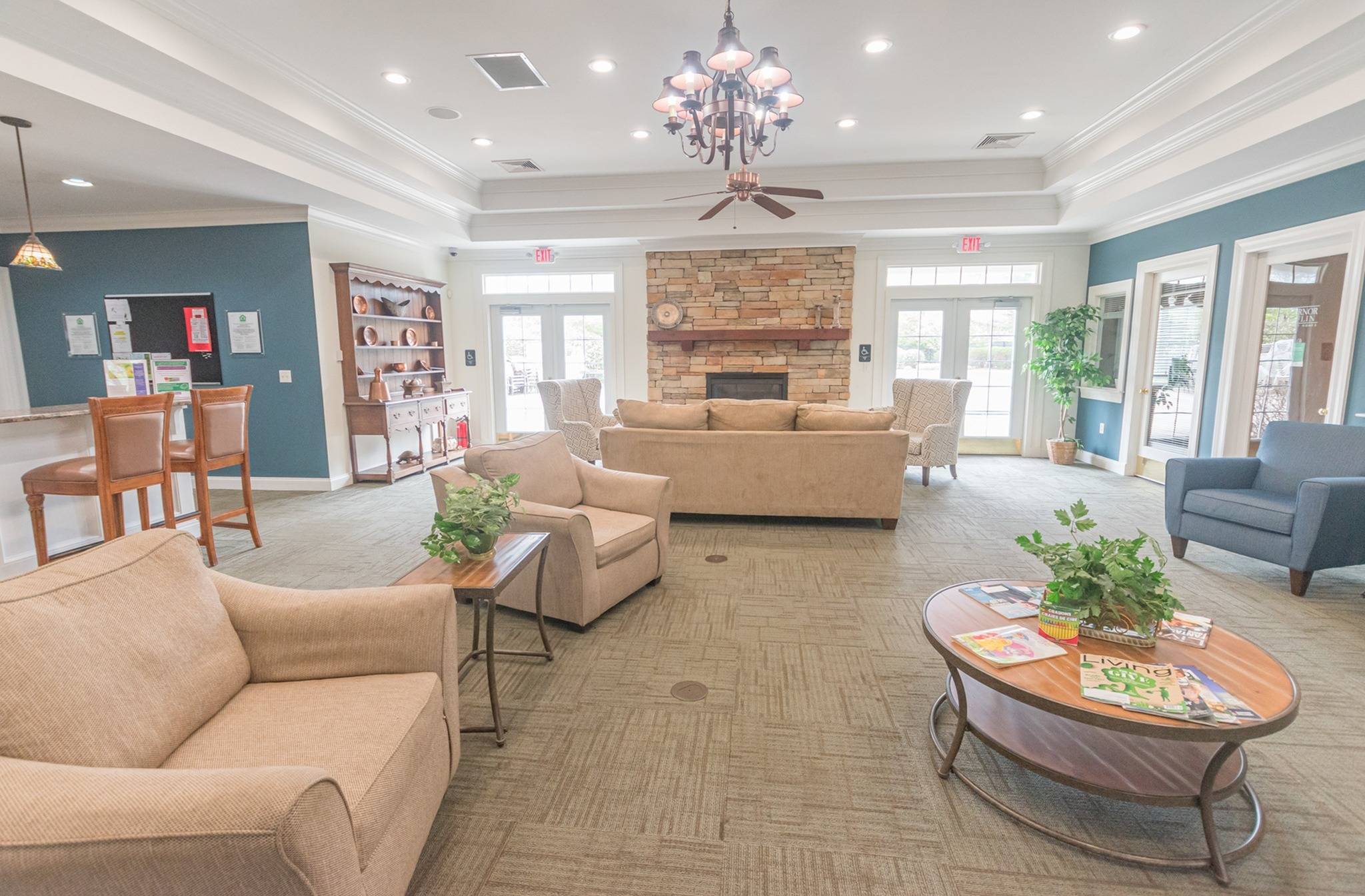 Spacious resident lounge with plenty of seating options and fireplace.