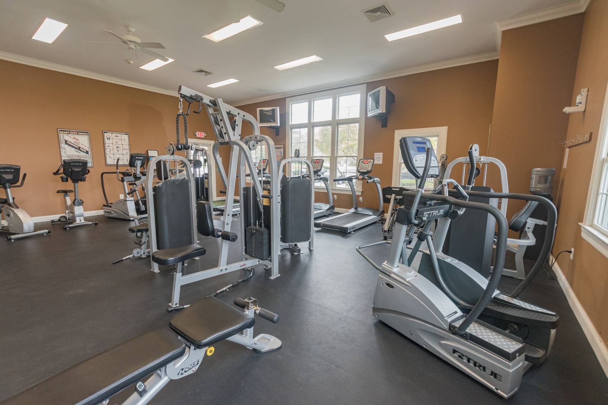 A wide variety of workout equipment in an indoor gym.