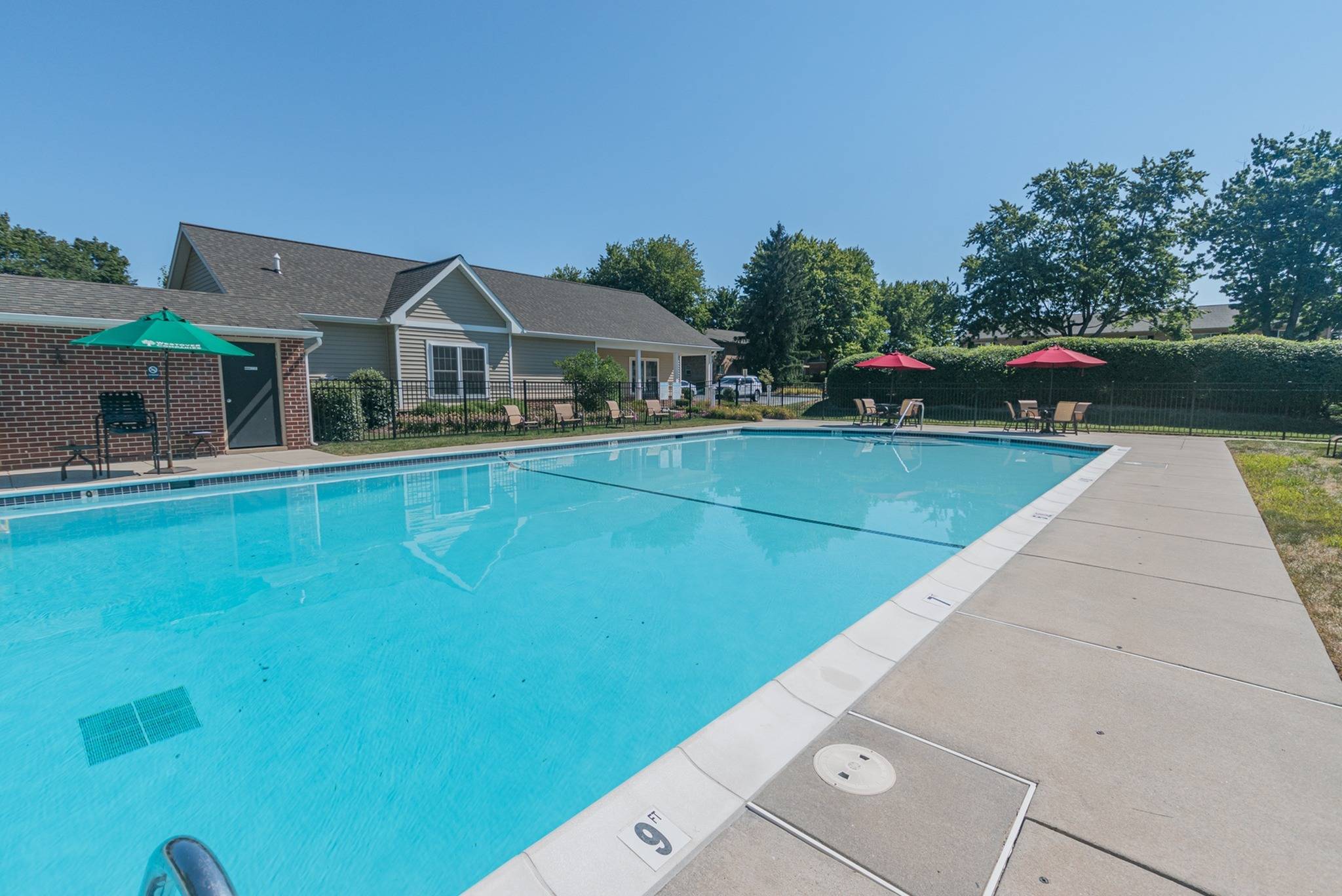 Woodland Plaza Apartments large swimming pool with tables and chairs