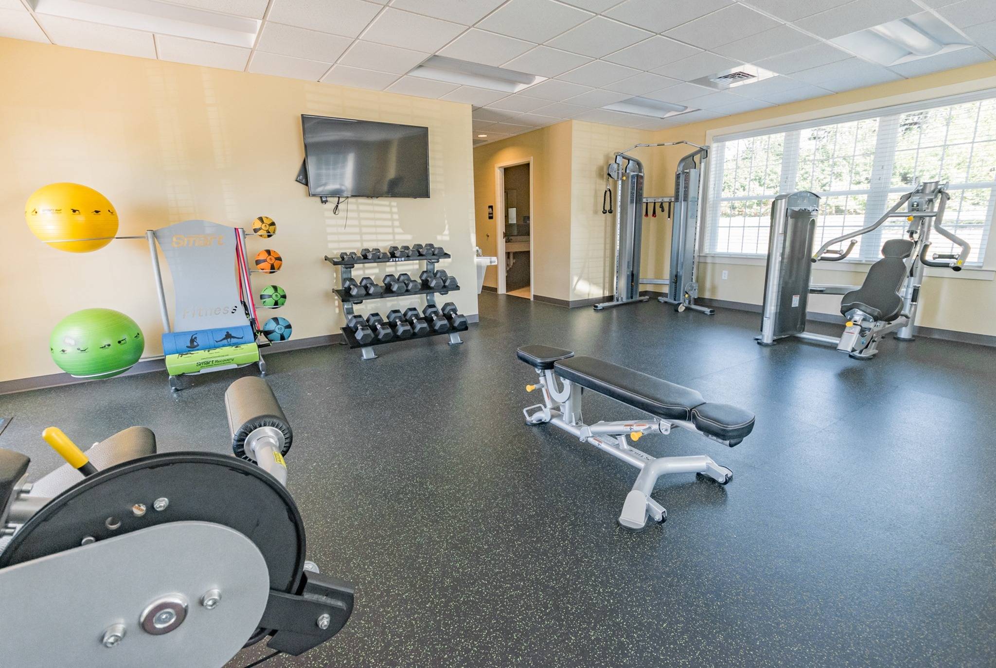 Woodland Plaza Apartments large fitness center with exercise equipment