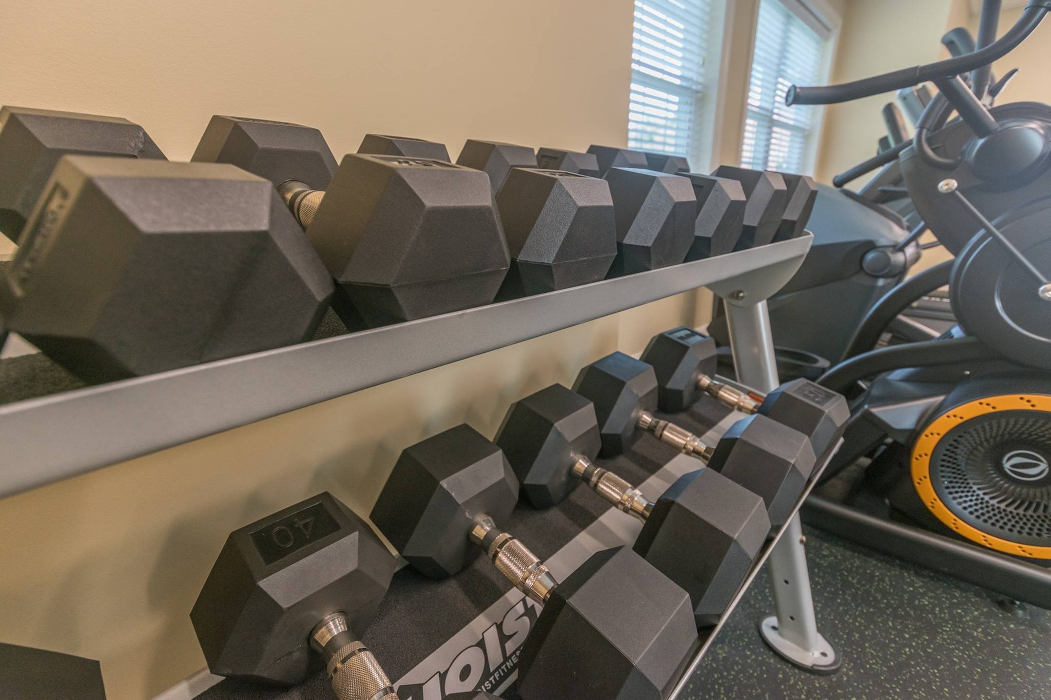 Weight rack at an indoor gym at Newport Village Apartments.